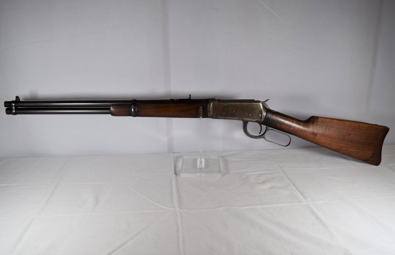 Winchester Model 1894 Rifle 30-30 Caliber: This nice gun is a Winchester Model 1894. 30 W.C.F. Serial Number: 1057053. Barrel measures 20in L. Clean Bore. Lever Action. Made in 1928. Embossed on sight Marbles Gladstone Mich USA. Functions as i