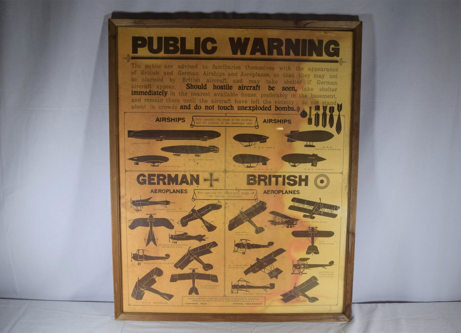 1915 World War One Public Warning Poster: World War One Public Warning Poster; framed poster provides instructions on what to do when you spot a German aircraft and gives a visual aid of the differences between British and German airships and