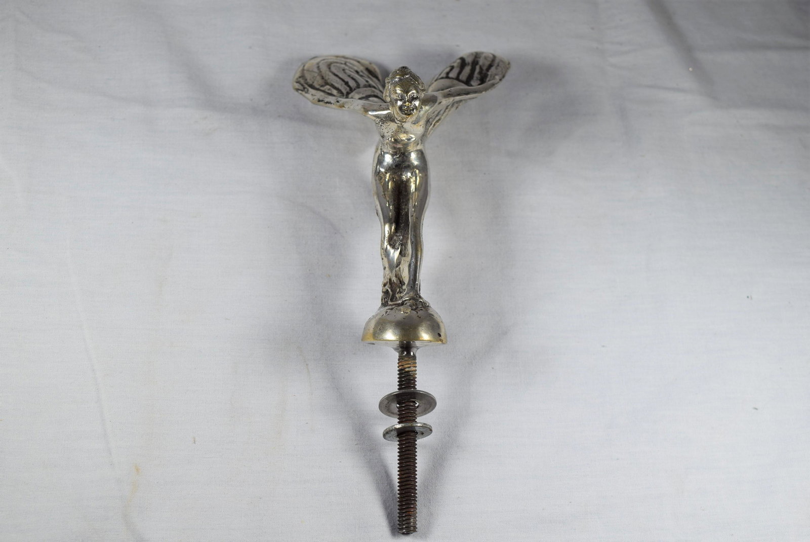 Early Rolls Royce Mascot: Early Rolls Royce mascot circa 1920s. Silver Ghost. Spirt of ecstasy, Charles Sykes Rolls Royce mascot. Solid steel, as the originals are. Note the details pictured. Measures approx. 8.25in L includin