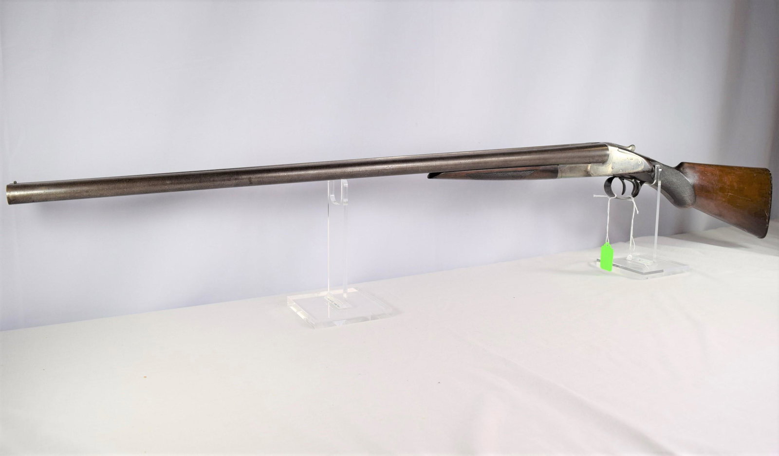 L. C. Smith Double Barrel Shotgun: L. C. Smith double barrel shotgun 12GA. BARREL: 30in L. SERIAL NUMBER: 108700. Nice checkering detail on forearm and stock. Smooth bore in good condition. Light handling ware, no chips or cracks seen.