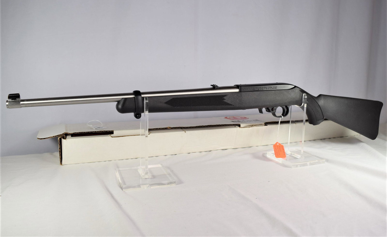 Ruger Model 10/22 Rifle .22 Caliber: Ruger model 10/22 rifle .22 caliber. Serial Number: 820-41163. Barrel 18in L. Front and rear sights. Stainless steel barrel. Gun is new old stock in the original box. Includes manual and gun lock. No 