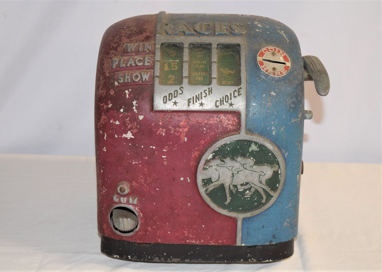 Vintage Miniature Slot Machine: Vintage miniature slot machine that reads RACES on top. Not currently functioning properly, needs some tinkering. Measures 10in T x 8.5in W x 7.5in D overall. Some paint loss and overall handling ware