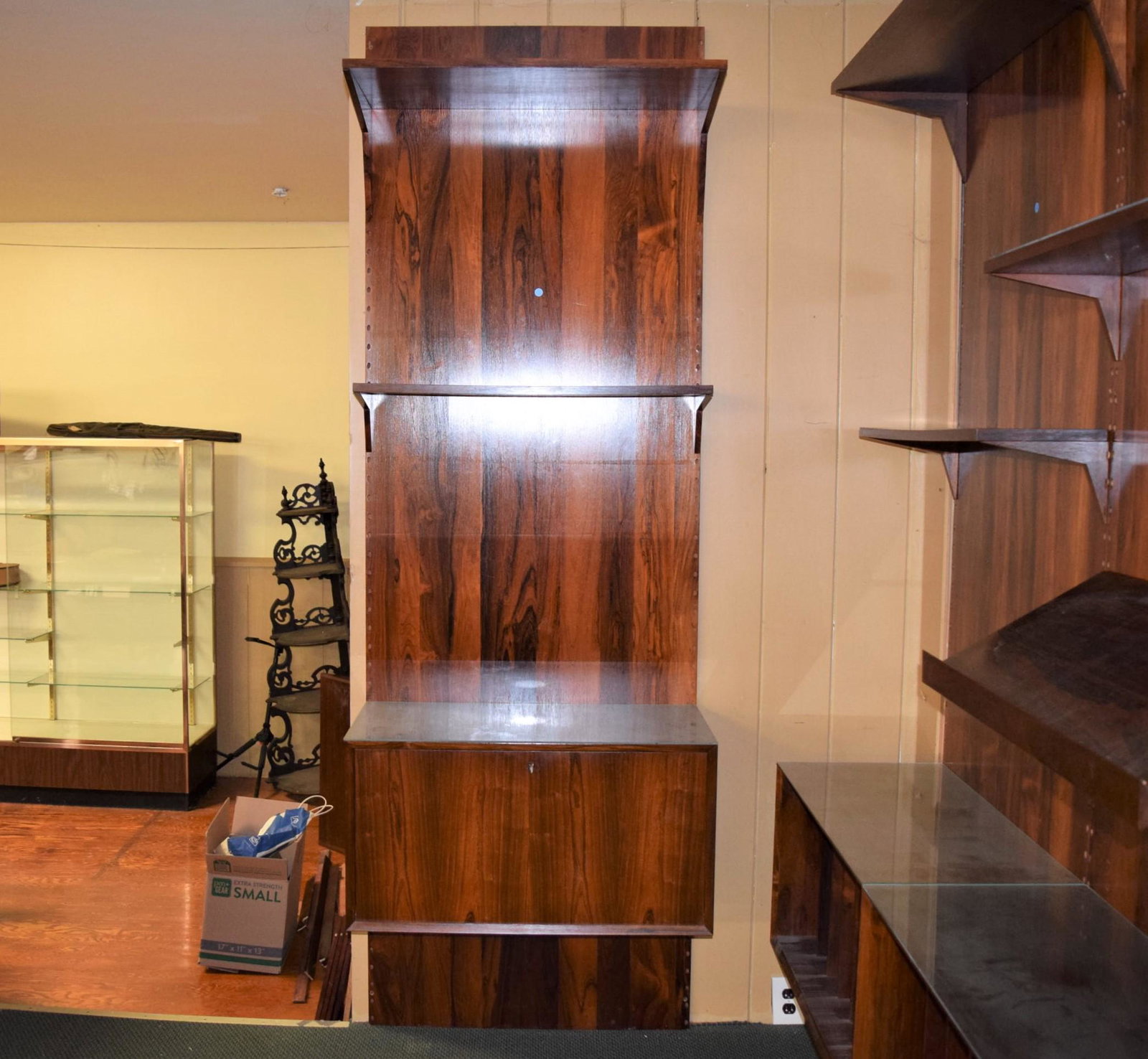 Mid Century Modern Rosewood Bar Wall Unit: Mid century modern rosewood bar wall unit. This unit measures approx. 8ft T x 31.5in W x 15.75in D overall. The bottom section features a flip down bar cabinet that measures approx. 15in D x 16.75in T