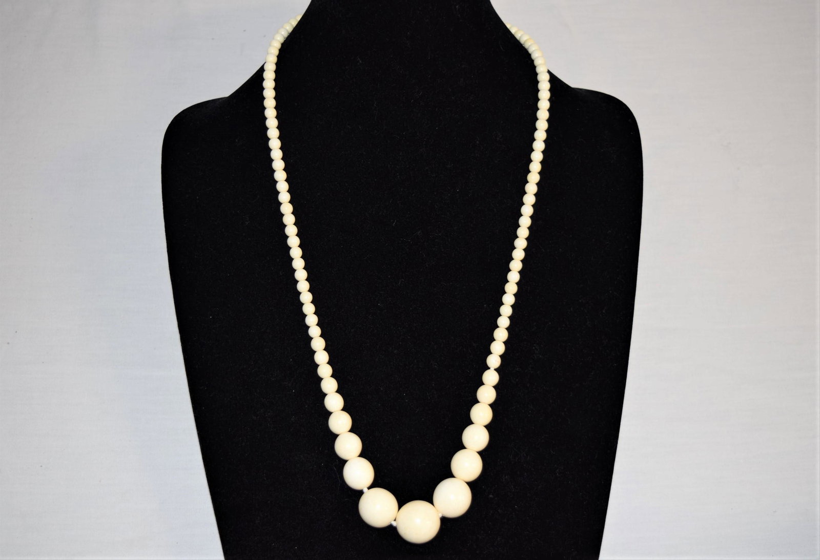 Vintage Estate Bone Bead Necklace: Vintage bone bead necklace measures approx. 29in L overall. The beads are larger at the bottom, the largest bead measuring approx. 18.6mm round, the smallest measures approx. 5.7mm round. Features twi