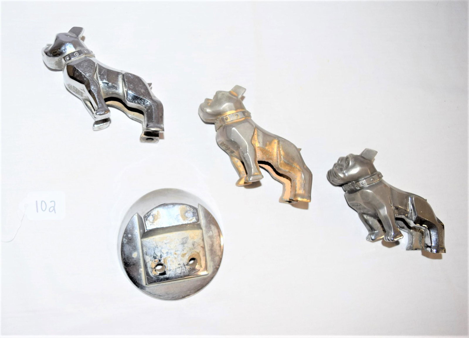 Vintage MACK Truck Bull Dog Hood Ornament: Vintage chrome MACK truck bull dog hood ornament lot includes three bull dogs and one base. Each dog is embossed DESIGN PATENT 87931 also embossed on the dogs collar MACK. The base is embossed on the 