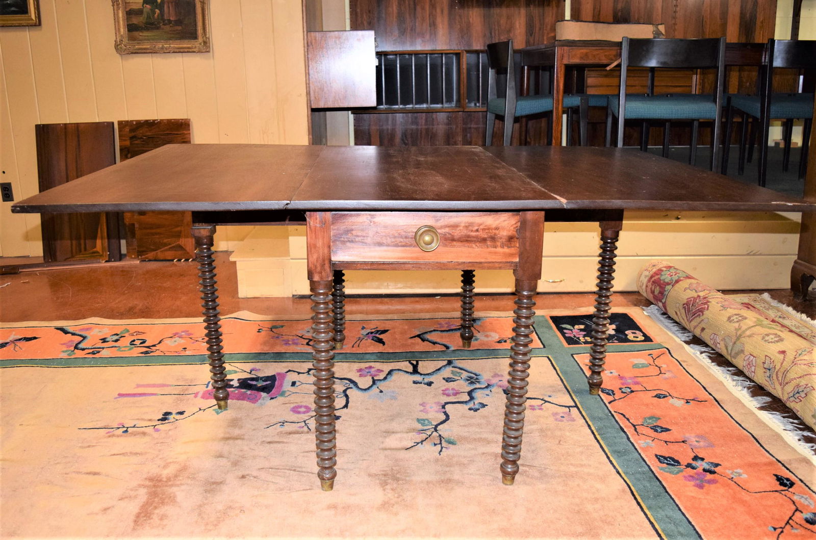 Antique Drop Leaf Turn Leg Table: Antique drop leaf turn leg table measures approx. 29.5in T x 48in L x 22in W, the two leaves measure 22.75in W. Features two drawers- one on each end, dovetail construction, beautiful turn legs. There
