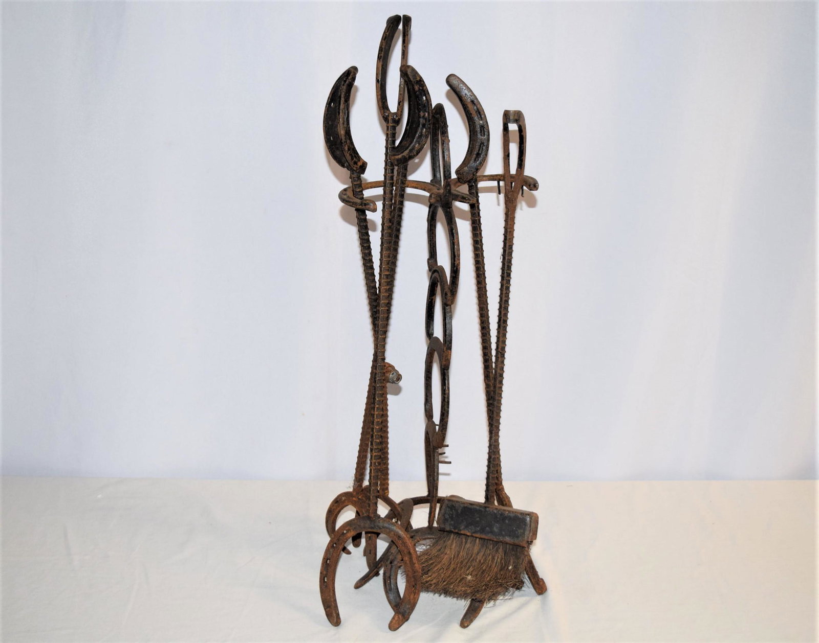 Antique Horse Shoe Fireplace Tools with Holder: Antique horse shoe shapped fireplace tools with holder. Horseshoe embossed Diamond Hot Forged at the top. Includes 4 fireplace tools; shovel, pocker, broom and claw grabber. Appears handmade. The hold