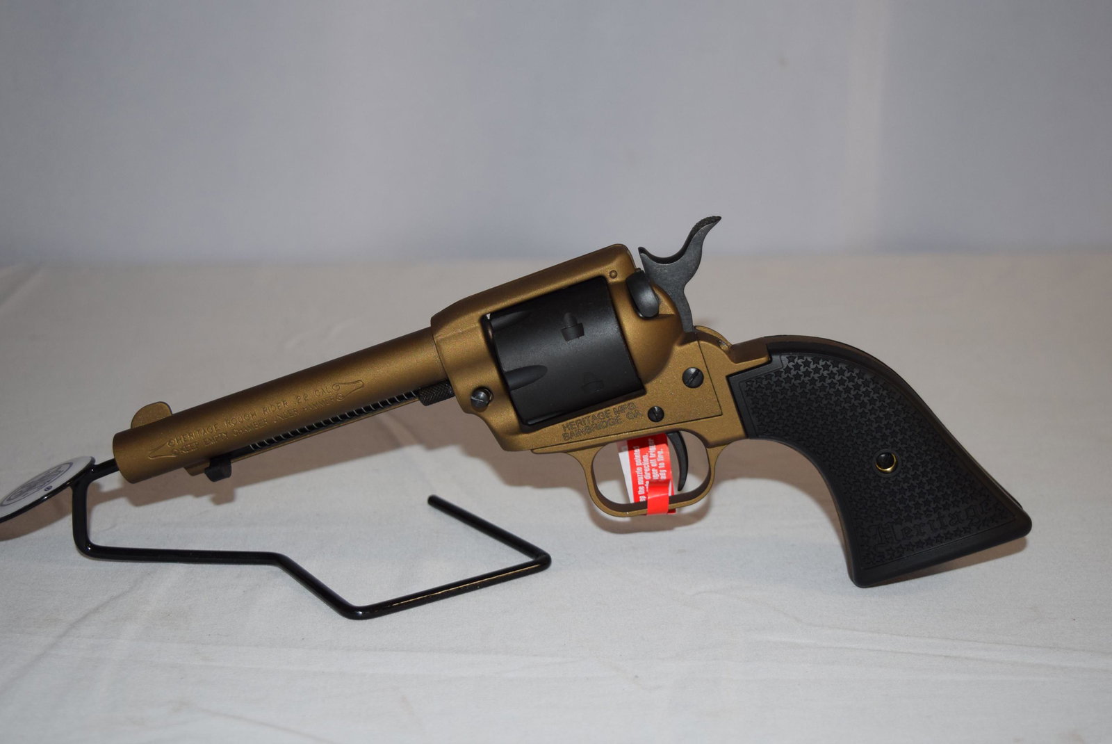 Heritage Rough Rider .22 Cal Revolver: NEW IN BOX Heritage Rough Rider Small-Bore .22 LR 6 Round Revolver. 4.75 inch Barrel. Serial Number: 3PH214262. Comes with original packaging including instruction manual and lock. Firearm appears to 