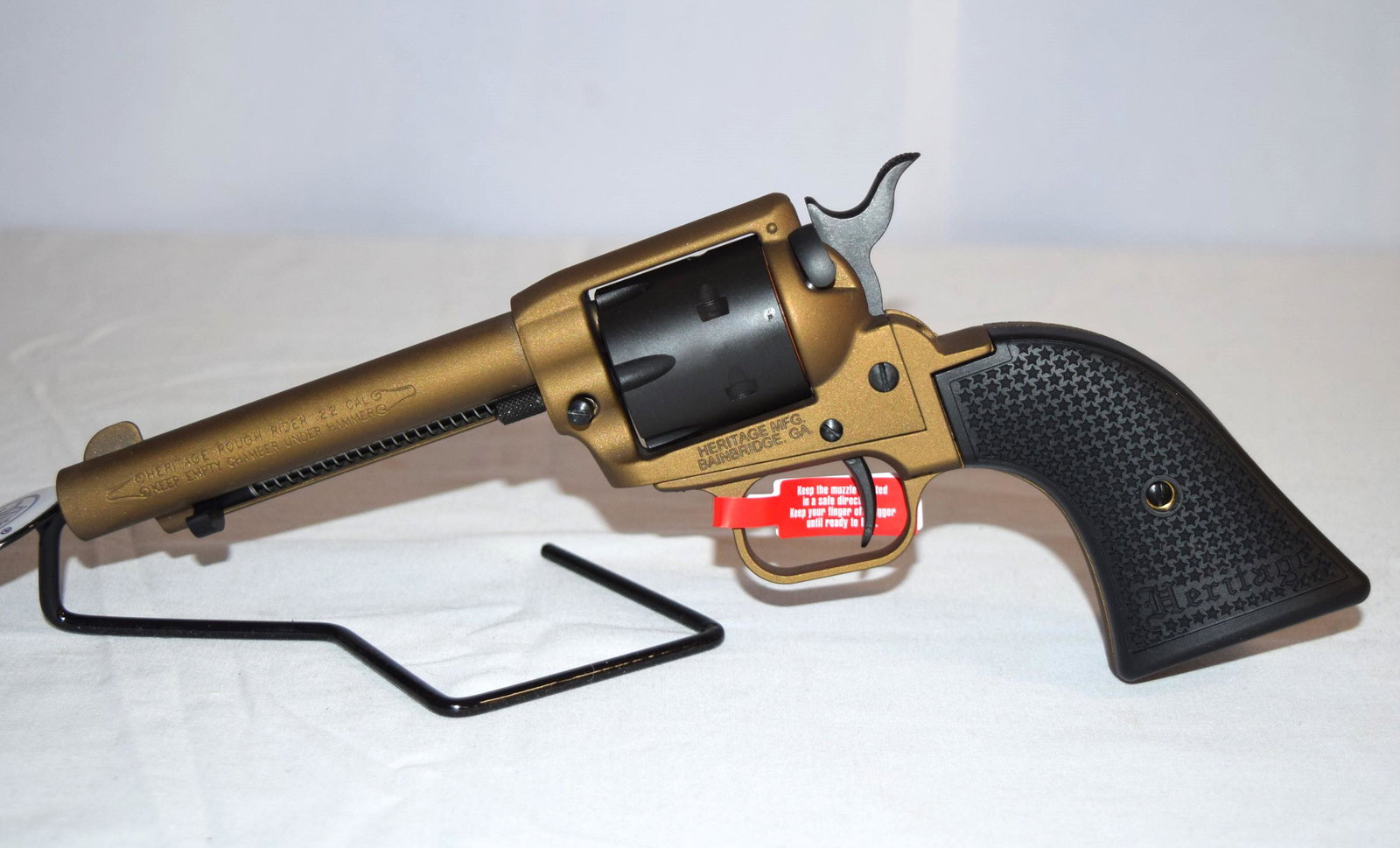 Heritage Rough Rider .22 Cal Revolver: NEW IN BOX Heritage Rough Rider Small-Bore .22 LR 6 Round Revolver. 4.75 inch Barrel. Serial Number: 3PH214375. Comes with original packaging including instruction manual and lock. Firearm appears to 