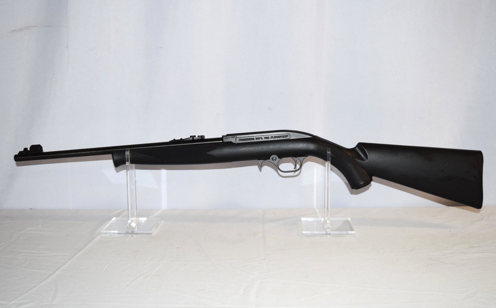 Mossberg 702 Plinkster .22 Cal Rifle: Mossberg International 702 Plinkster .22 Cal Rifle. Front Sights. Checkered Forestock and Pistol Grip. 18 Inch Rifled Bore Barrel. Serial Number: EHK418096. Still has original box, complete with instr