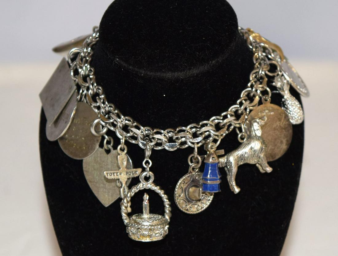 Rhythm Sterling Silver Charm Bracelet: Rhythm Sterling Silver Charm Bracelet features several charms all around with 5 extra loose charms. All together this bracelet weighs approximately 77.1 grams! Some charms are engraved, birthday charm
