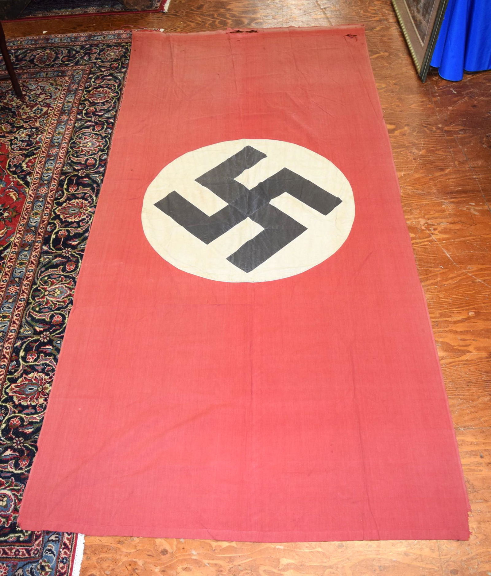 Authentic German WWII Flag: Authentic German WWII Flag measures 110 inches long X 48 inches tall. Some fading consistent with age and minimal tearing or fraying on the edges, as photos show. Well persevered piece of history to d