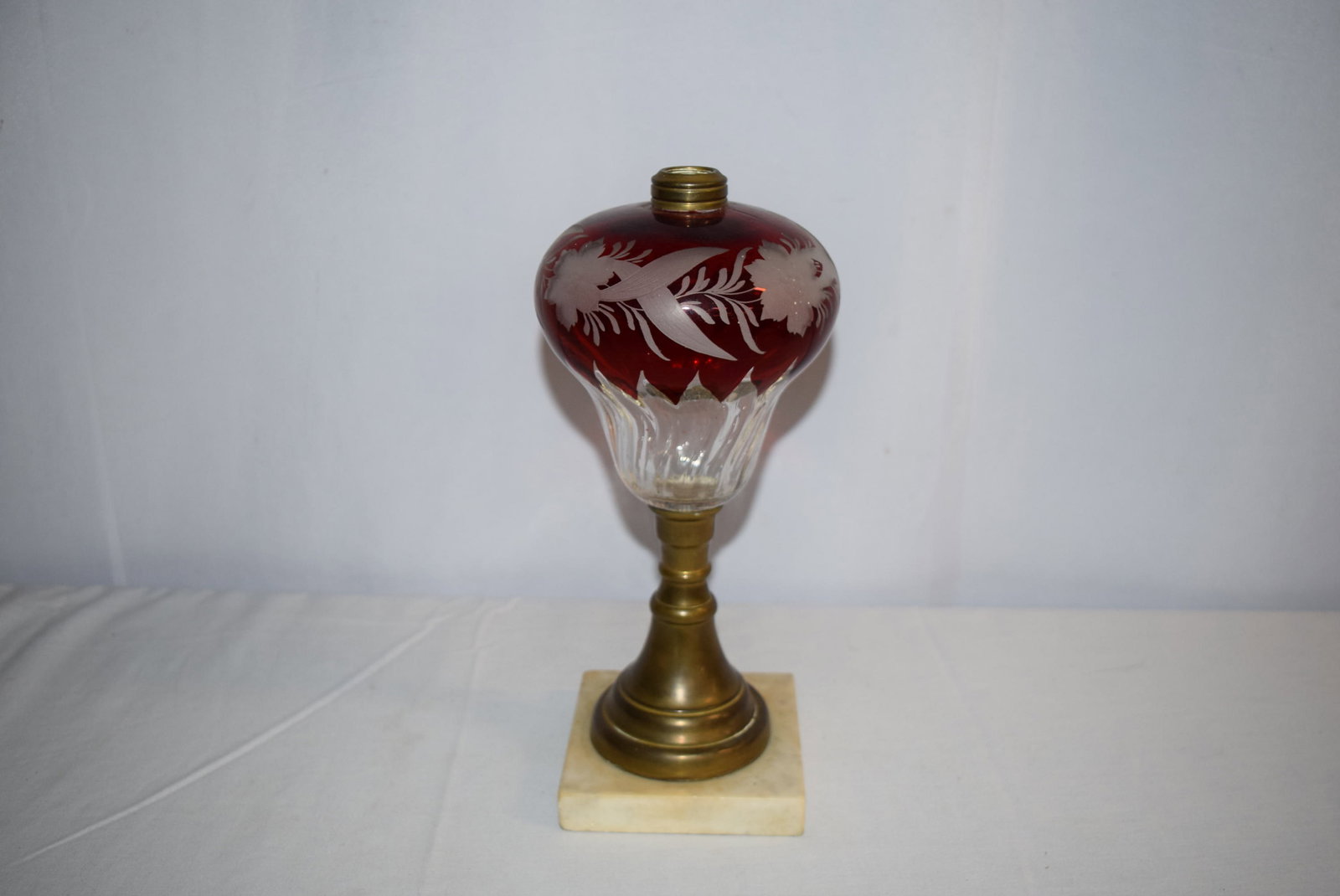Vintage Marble and Brass Base Oil Lamp: Cranberry and clear glass with floral detail. Marble base measures approximately 4.75 inches square. Overall lamp measures 12.5 inches tall. Slight imperfections, as shown in photos, otherwise would d
