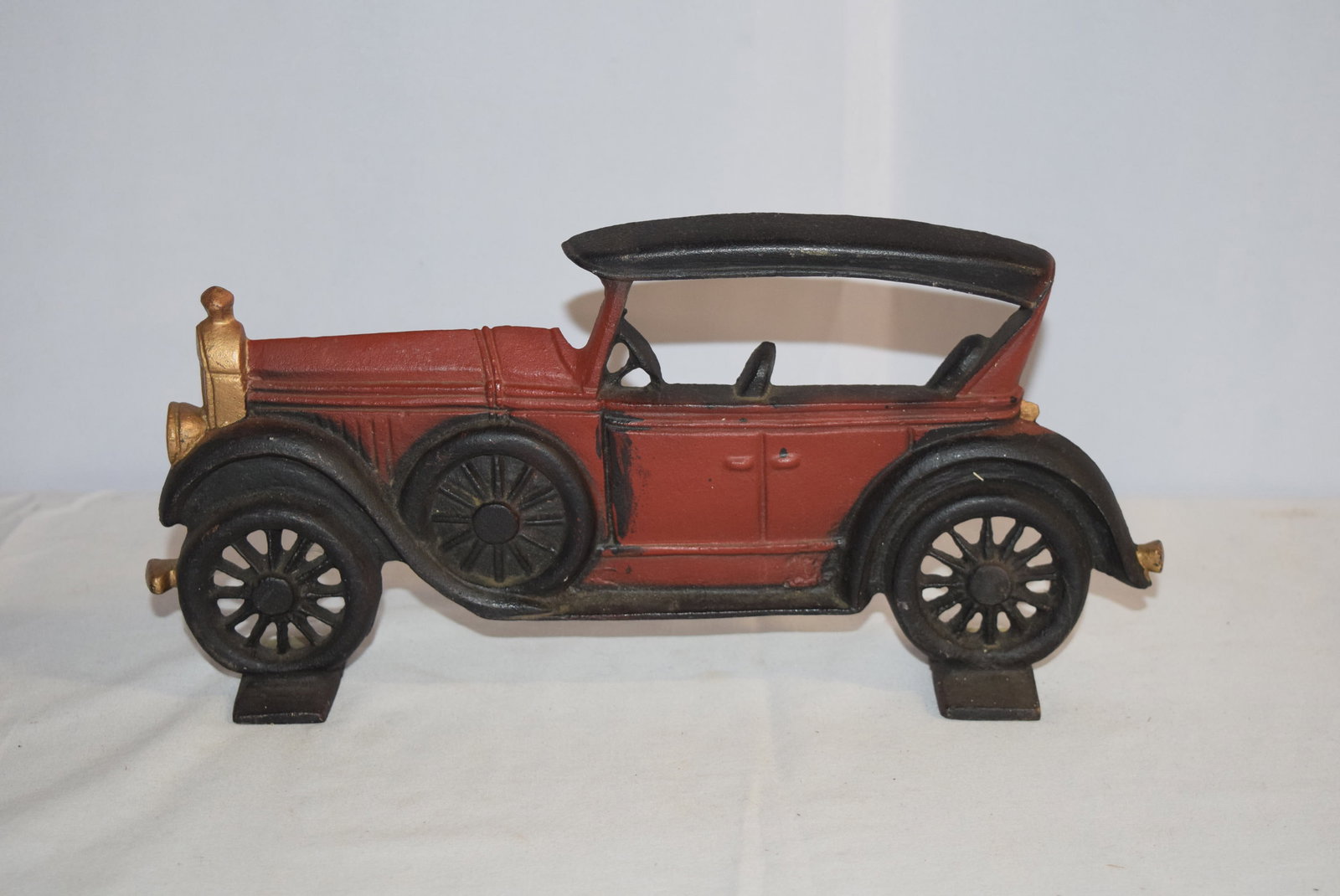 Vintage Cast Iron Model T Car Doorstop: Vintage Cast Iron Model T Car Doorstop. Embossed with a "C" on the backside. Appears to be repainted, otherwise is in good overall condition and would display well in anyones home, shop or office. Mea
