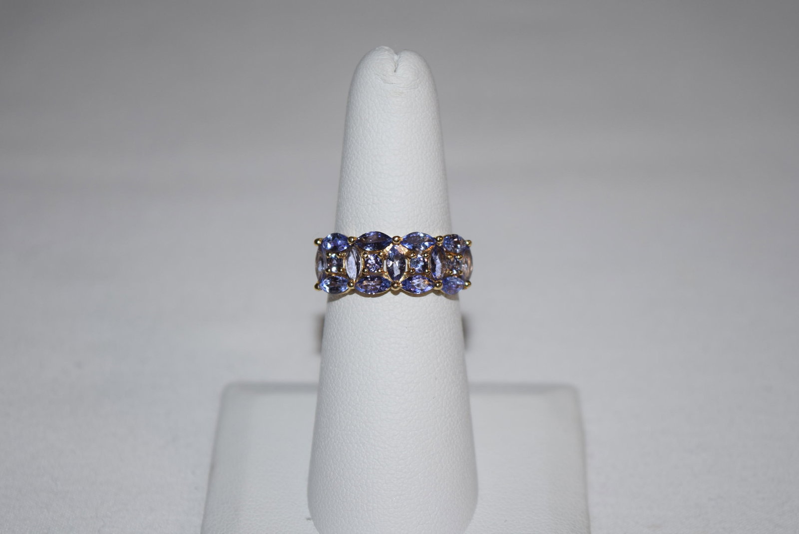 14K Yellow Gold Tanzanite Ladies Ring: 14K Yellow Gold Tanzanite Ladies Ring currently measures a size 6 and weighs approximately 2.5 grams. Features a interesting design using marquise cut tanzanite stones encircling a round cut gem in th