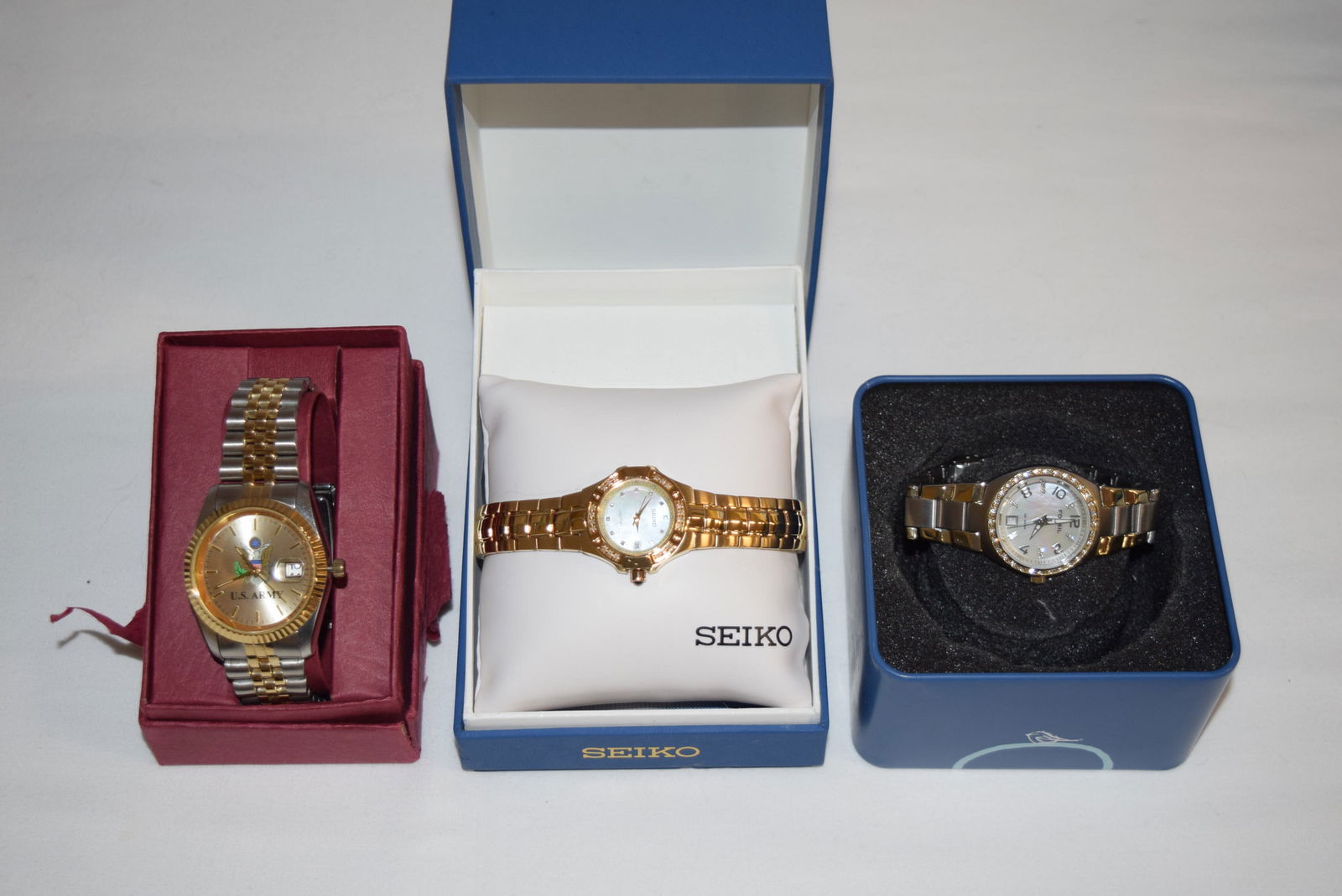 Lot of Three Watches in Boxes: Lot of Three Watches in Boxes includes: SEIKO Coutura, FOSSIL 10 ATM, Frontier Model 11B US Army Watch. All watches come in their original boxes and two of the watches come with spare links for future