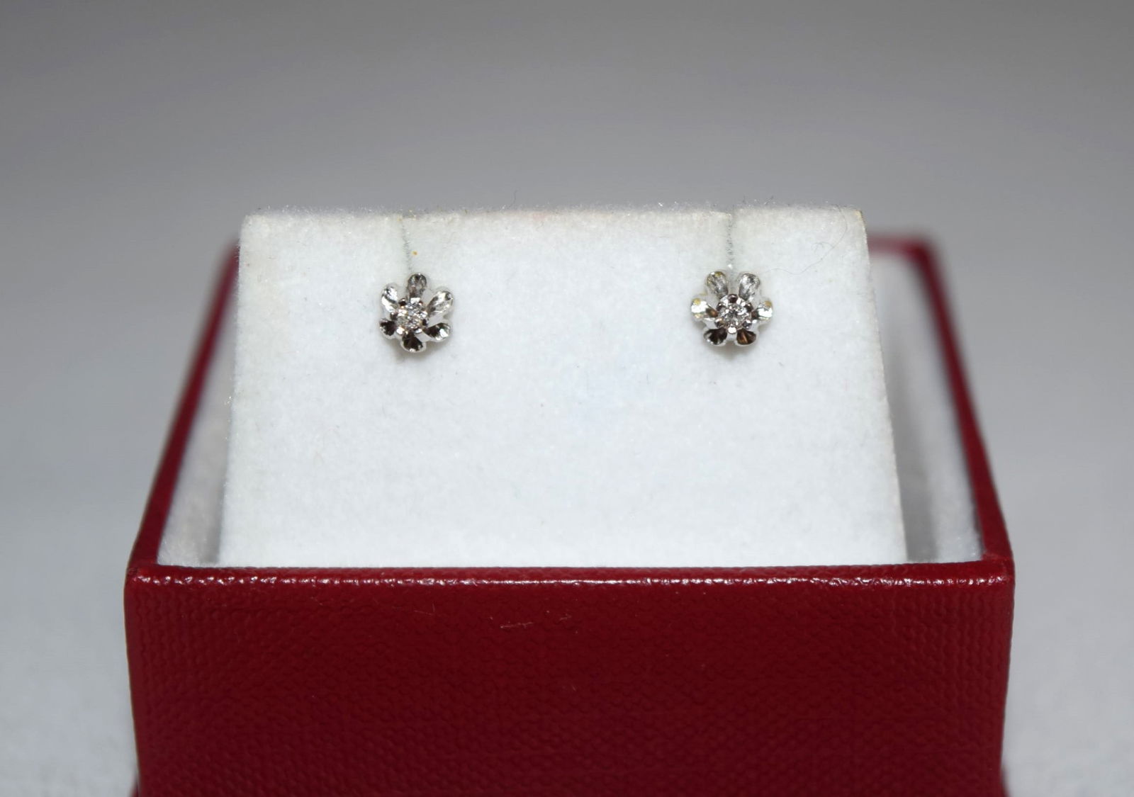 Pair of 14K White Gold Diamond Stud Earrings: Pair of 14K White Gold Diamond Stud Earrings measure 4.5mm round overall with a 2mm round diamond at the center of each stud. These earrings were tested 14K and marked 14K on the backs, weighing 1.1 g