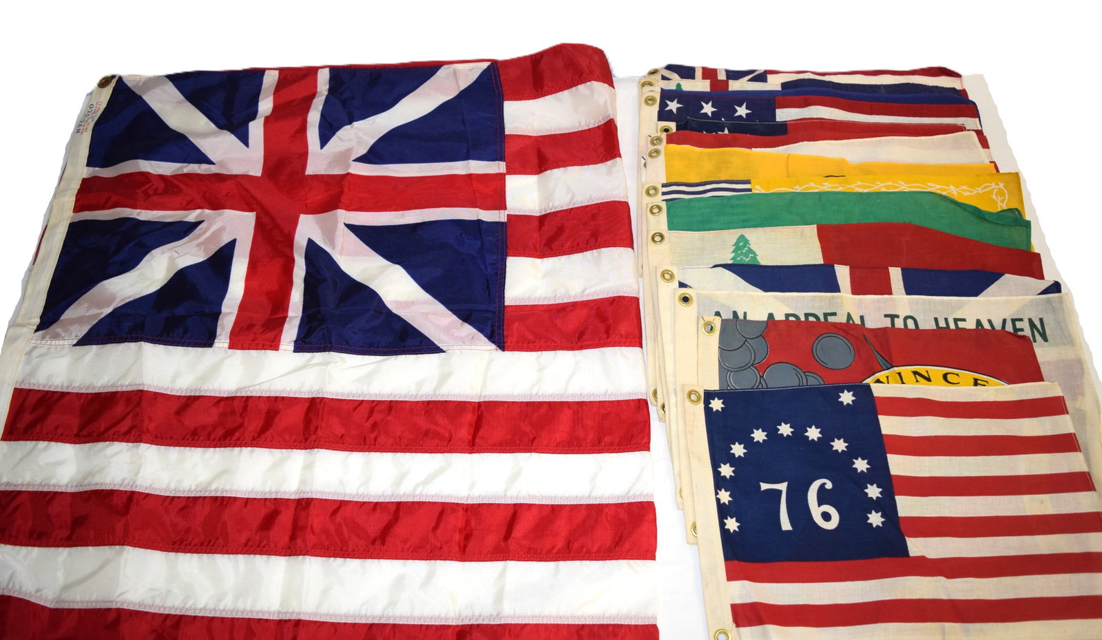Large Lot of Various Historical Reproduction Flags: Large Lot of Various Historical Reproduction Flags. Includes several garden sized flags each measuring approximately 19.5 inches across X 12 inches wide, and regular sized NYL-GLO 100% British Union F