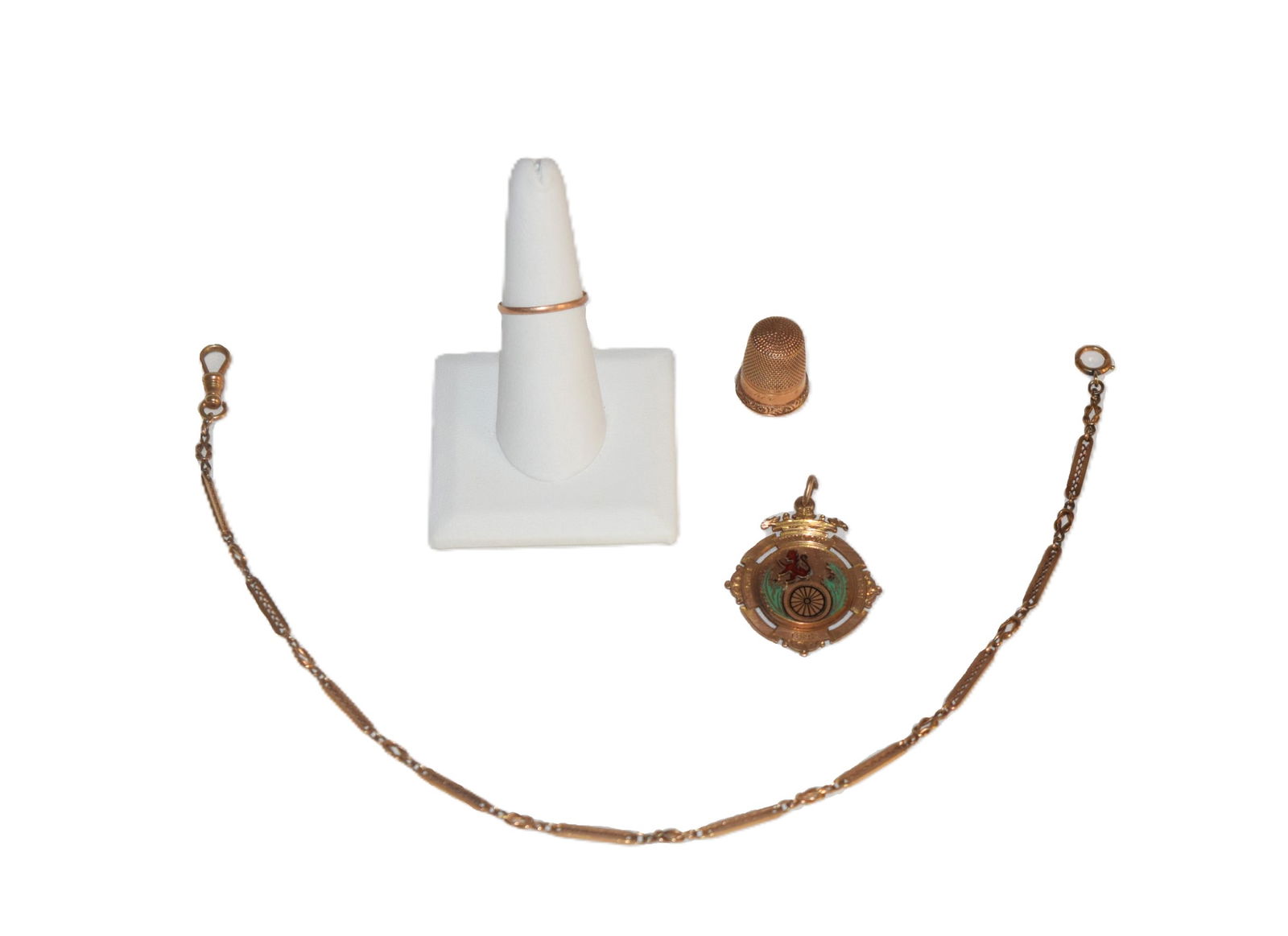 Lot of Miscellaneous Yellow Gold: Lot of Miscellaneous Gold includes a thin band, a thimble, a pendant medal, and a watch fob. The thin band has a break, tested 10K , measures about a size 6.5 and weighs approximately 0.5 grams. The t