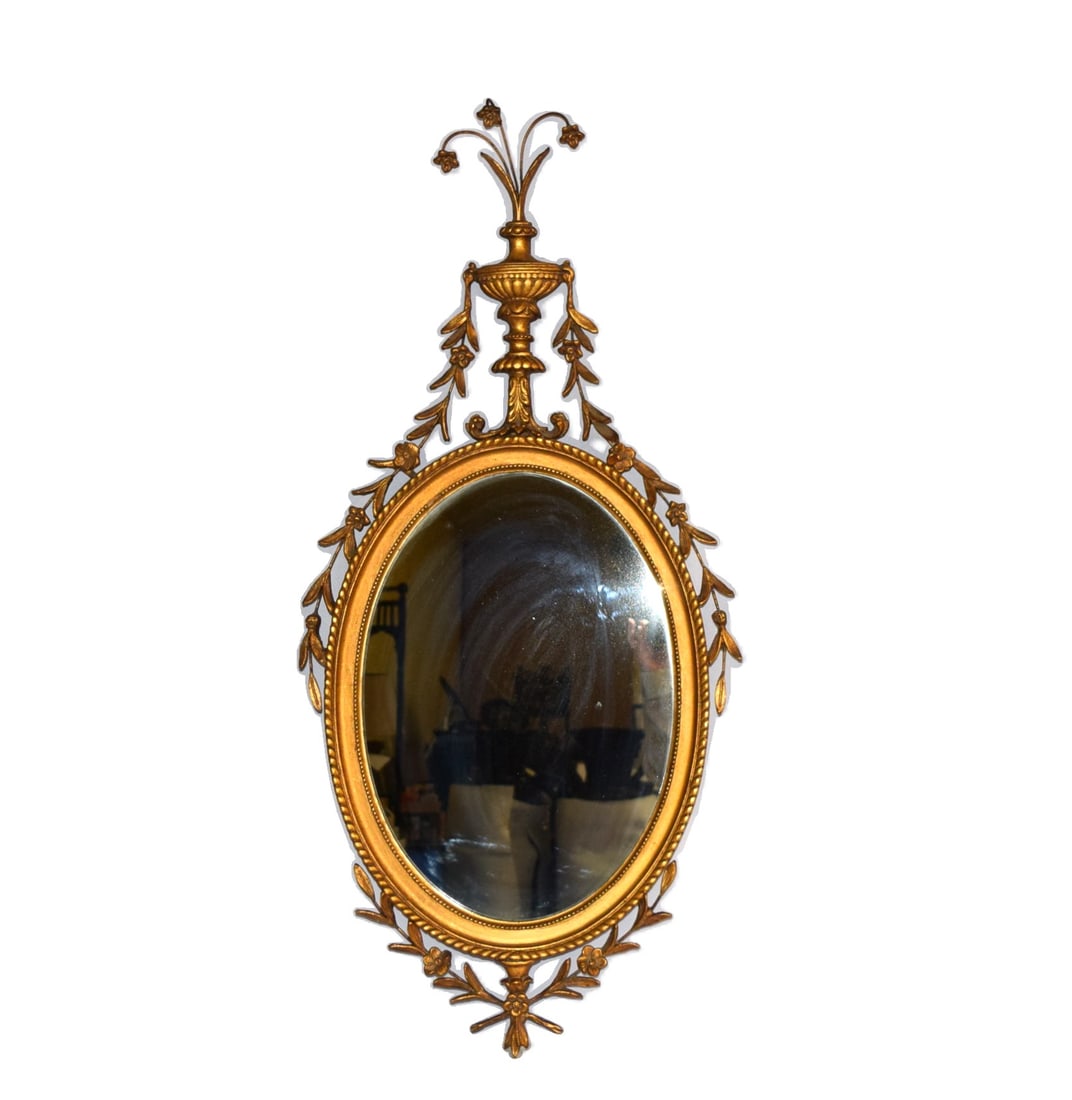 Antique Italian Style Gold Gilt Oval Mirror: Antique Italian Style Gold Gilt Oval Mirror is highly ornate, featuring florals and leaves which wrap around the outer edge of the mirror. As well as a pedestal vase which sits at the top of the mirro
