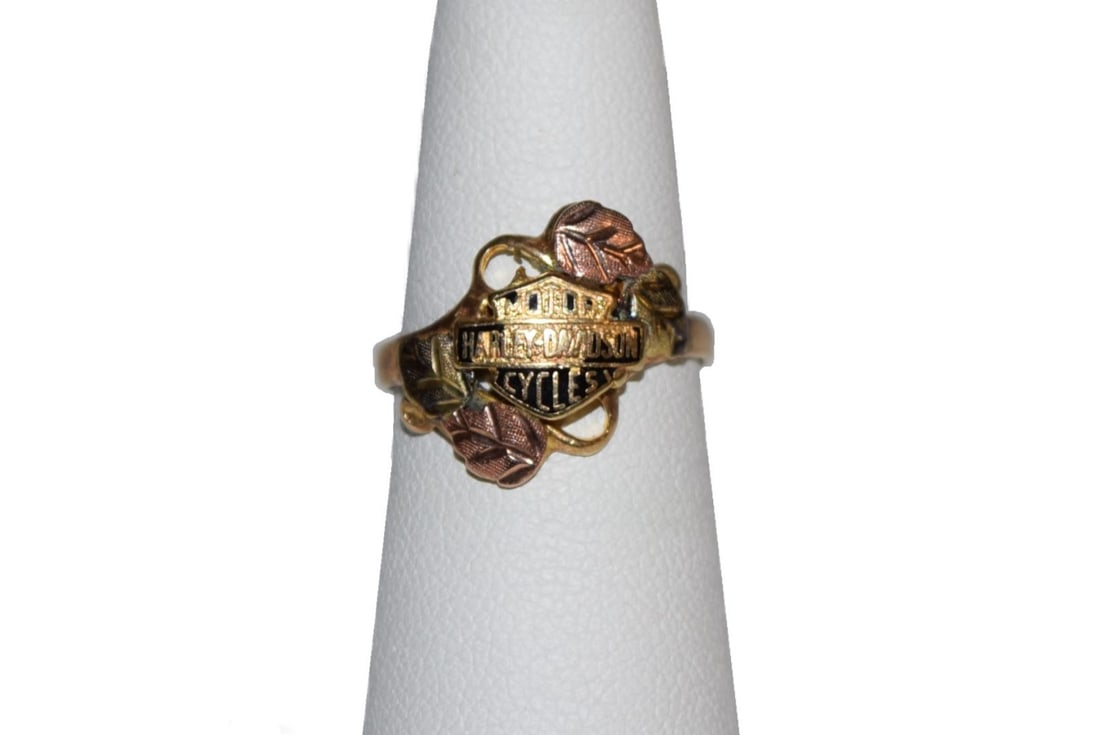 10K Tri Tone Gold Harley Davidson Estate Ring: 10K Tri Tone Gold Harley Davidson Estate Ring currently measures a size 6 and weighs approximately 2.7 grams. Ring is was acid tested, not marked, by auction house and showed 10K gold. Features both y
