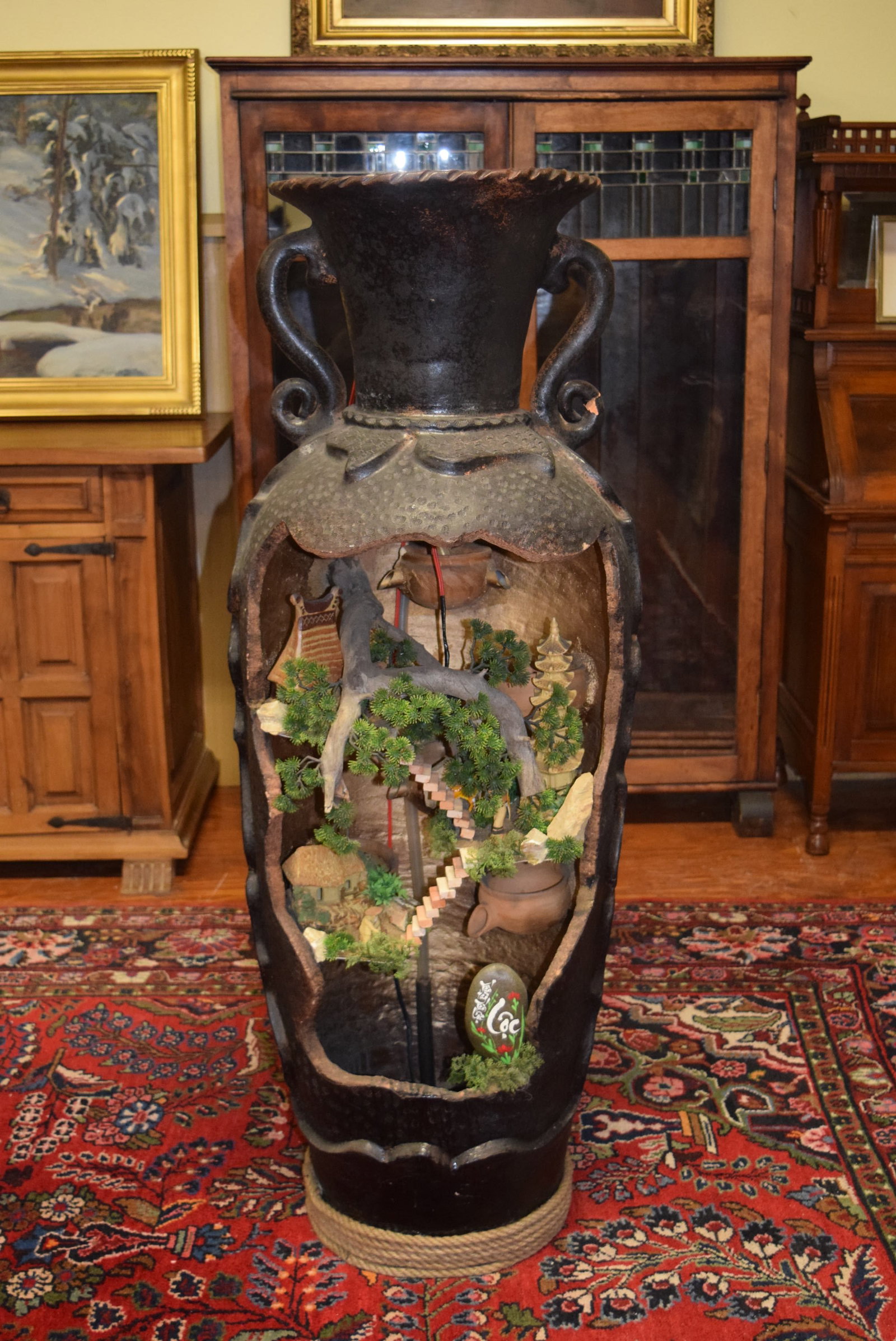 Large 4 Foot Tall Oriental Waterfall Cutout Urn: Large 4 Foot Tall Oriental Waterfall Cutout Urn stands approximately 48 inches tall overall X 14 inches round on top X 16 inches wide across the front opening. Features a miniature village scene with 