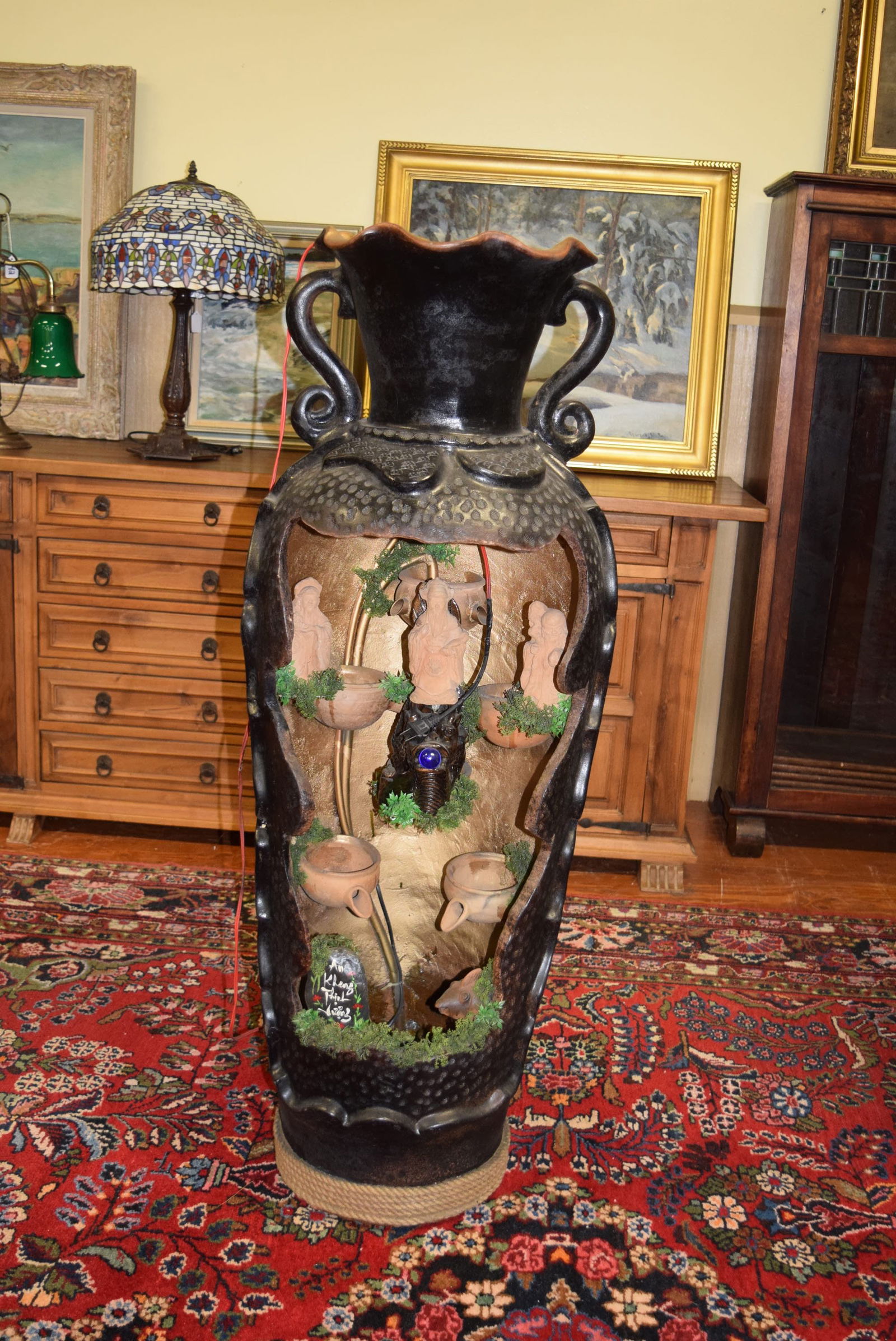 Large 4 Foot Tall Oriental Waterfall Cutout Urn: Large 4 Foot Tall Oriental Waterfall Cutout Urn stands approximately 48 inches tall overall X 14 inches round on top X 16 inches wide across the front opening. Features three figural statues spread ou