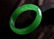 A NATURAL GREEN JADE BANGLE. - 6