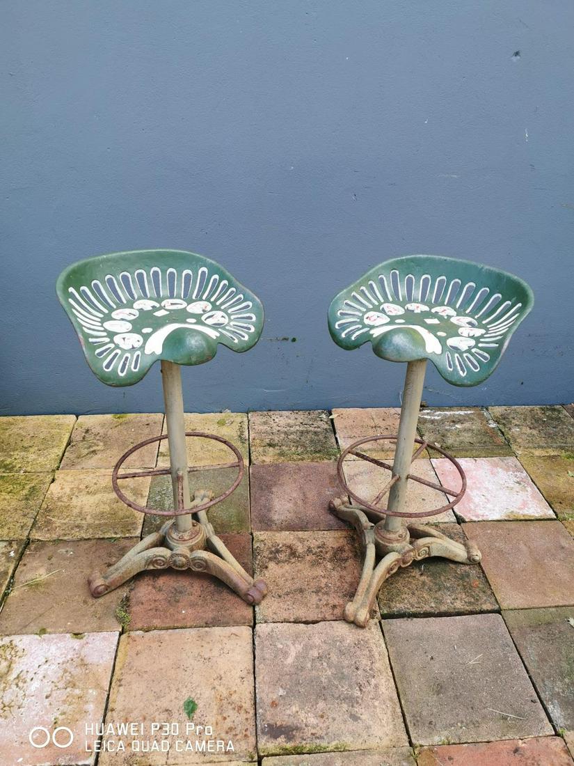 Pair of cast iron Slattley tractor seat bar stools.: Pair of cast iron Slattley tractor seat bar stools {79 cm H x 41 cm Dia.}.