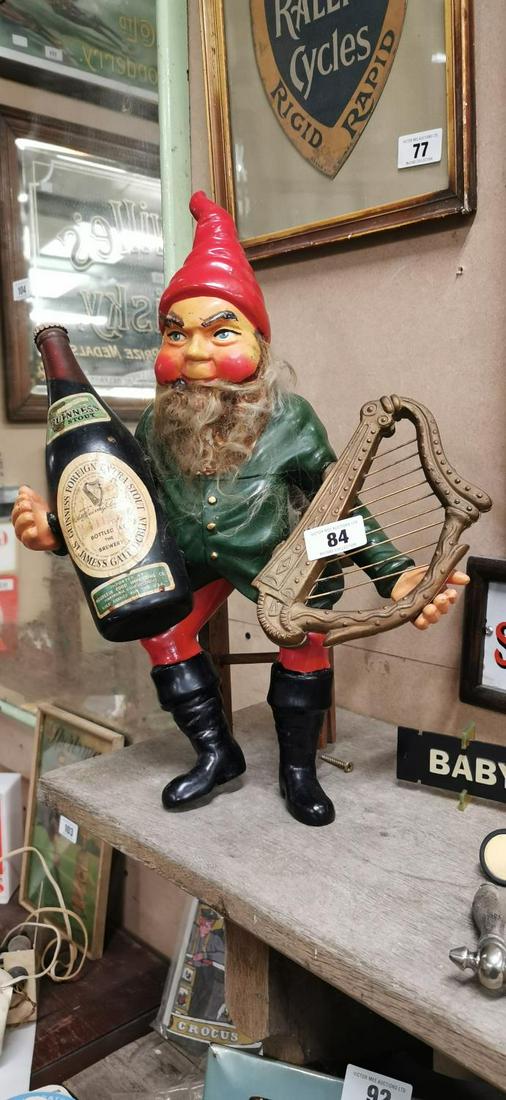 Rare 1960's Guinness Ruberoid advertising Leprechaun: Rare 1960's Guinness Ruberoid advertising Leprechaun seated on a wooden stool holding a bottle of Guinness and a harp . { 48cm H X 37cm W }. The leprechaun was used by GEL to advertise stout to the ov