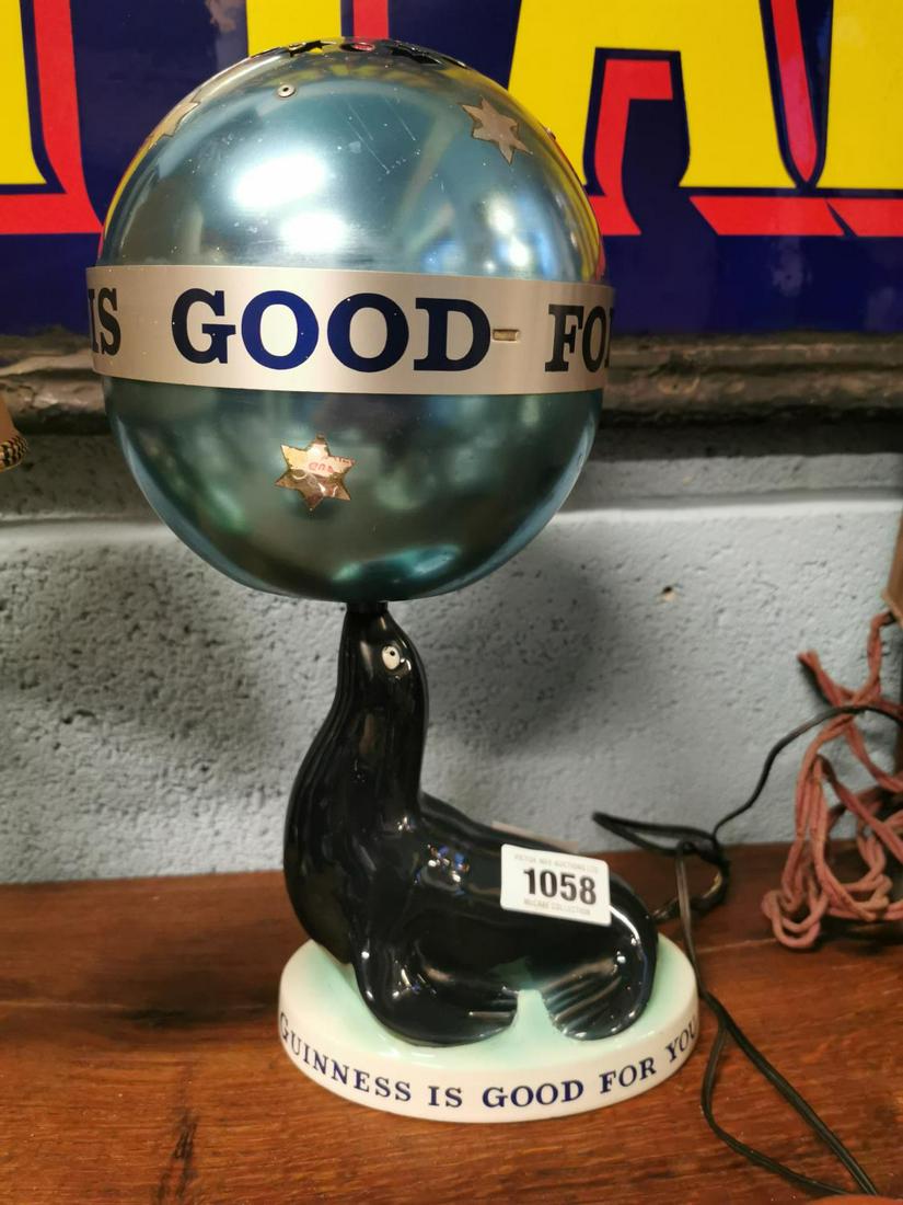 Guinness Seal lamp: Rare original Carlton ware Guinness Seal lamp with original self revolving shade. { 28cm H }.