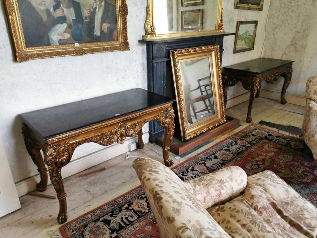 Pair of gilt console tables: Pair of gilt console tables, the marble tops above the frieze decorated with lion's masks and and raised claw and ball feet, in the Victorain style. {80 cm H x 102 cm W x 60 cmD}