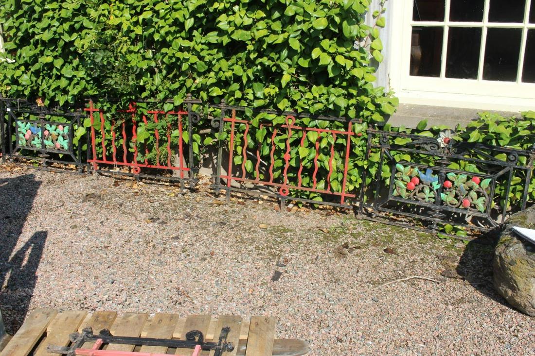 Set of five cast iron window guards, two with floral: Set of five cast iron window guards, two with floral decoration. {70 cm H x 500 cm W in total}