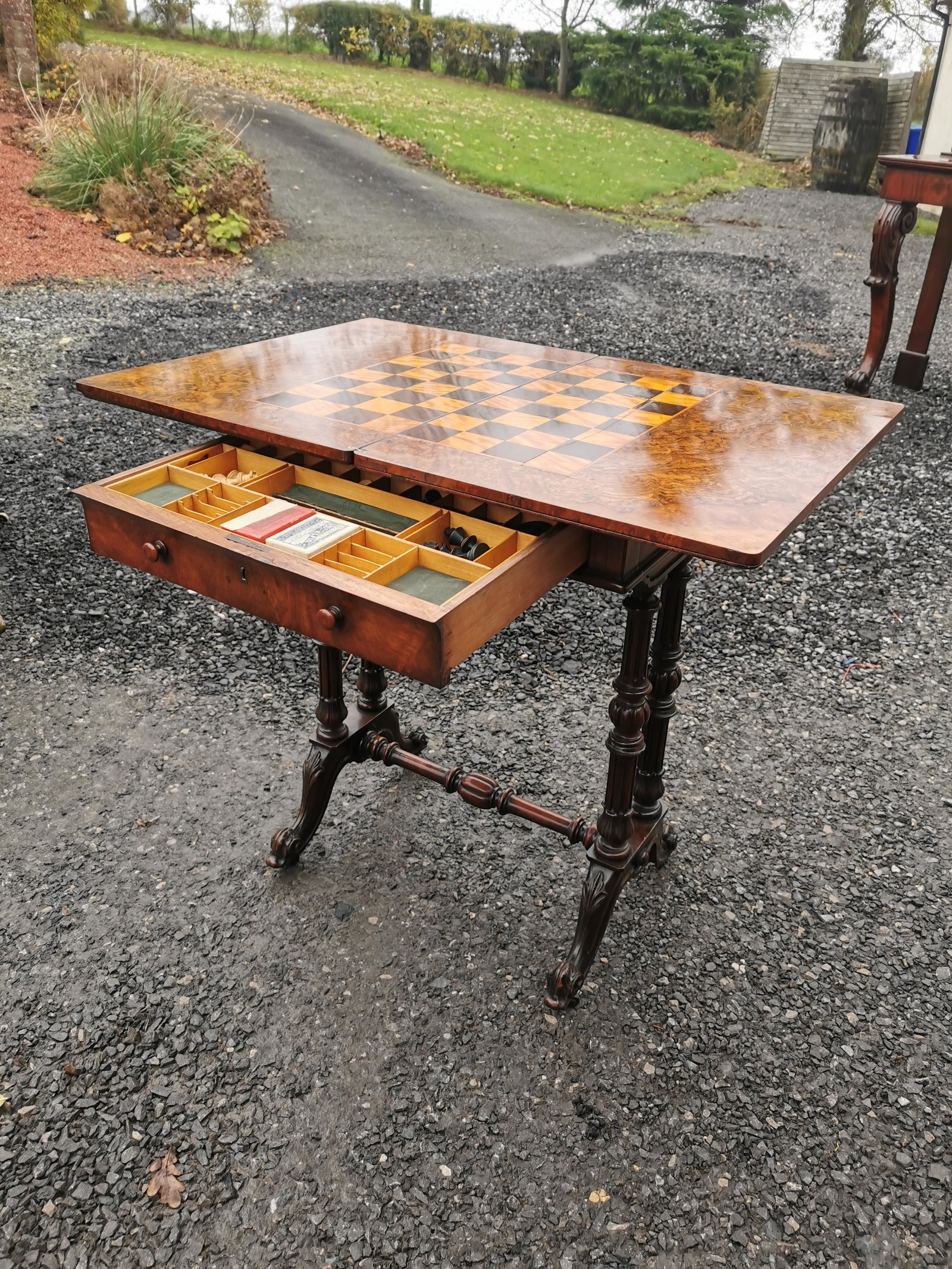 Victorian burr walnut games table with accessories: Victorian burr walnut games table with accessories raised on carved turned legs {74 cm H x 56 cm W x 40 cm D}.