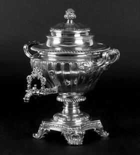 A George IV Silver Hot Water Urn by Richard Sibley: A sterling silver hot water urn hallmarked for London, 1827 and the maker Richard Sibley. It features shell and acanthus leaf decorated scrolled feet, gadrooning, a fluted body, reeded and acanthus de