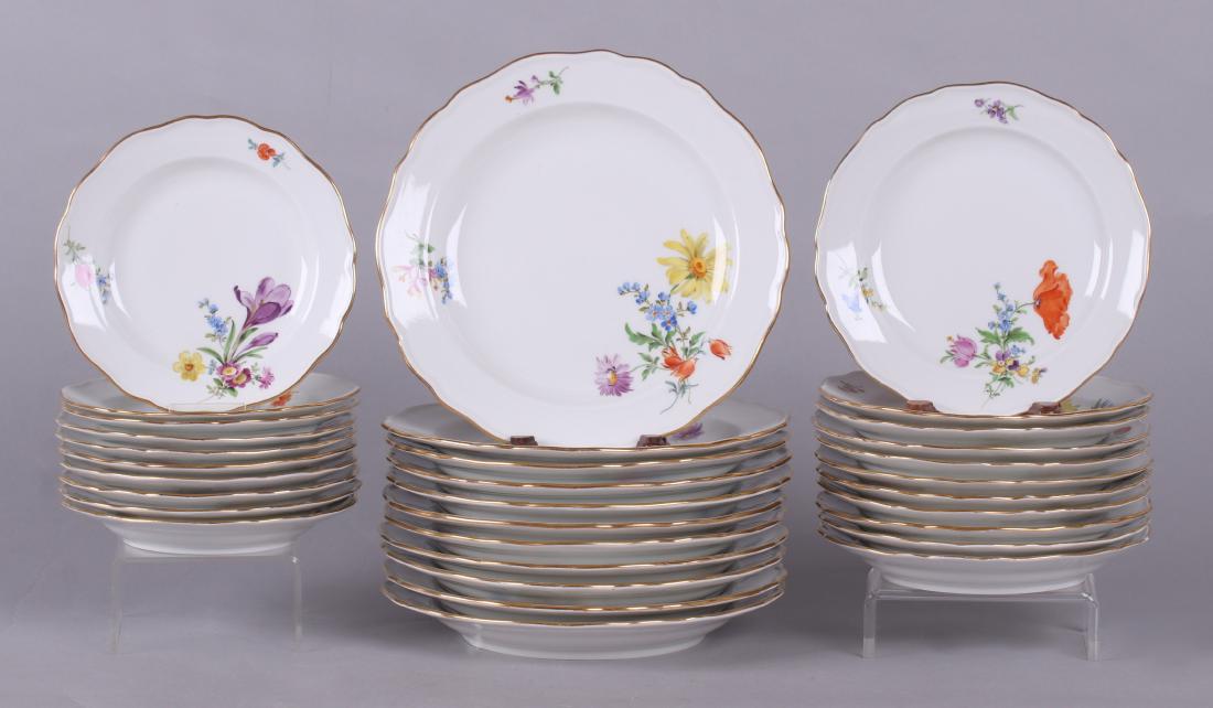 A Set of Thirty-Two Porcelain Meissen Plates: Late 19th century, each with a scalloped rim, gold piping and hand painted floral decoration; marked as pictured. Comprising eleven 8 1/2" salad plates, eleven 7" dessert plates, and ten 6 1/4" bread