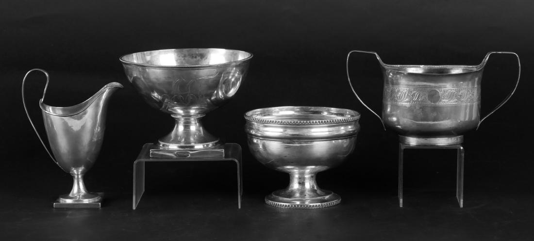Three Pieces of American Coin Silver Hollowware: All early 19th century and unmarked, two wastebowls, and a helmet form creamer . The lot also includes an Old Sheffield Plate sugar bowl from the same period. Dimensions: From 5" x 2 3/4" to 8" x 4 1/