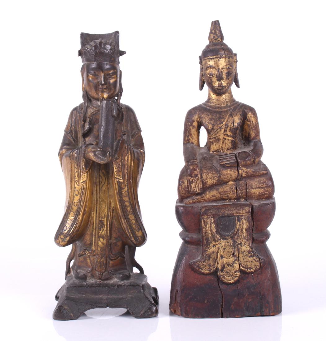 Two Asian Figures, Bronze and Wood: A Qing Dynasty gilt bronze figure of a scholar and a Southeast Asian giltwood figure of a seated Buddha. Dimensions: The bronze is 3 1/4" x 3" and 9" tall, the wooden example is 3 1/2" x 2 1/2" and 9 