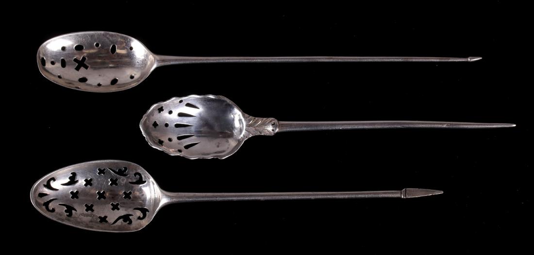 Three British Sterling Silver Mote Spoons: Three pierced examples, one also with a shell form bowl, the hallmarks are rubbed and unidentifiable, however the shell form example is marked "PR" and appears to be Patrick Robertson; the other two a