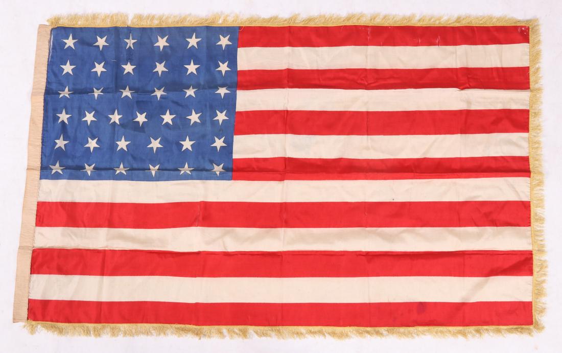 An American 37 Star Flag Circa 1870: Silk , hand stitched and with gold fringe. According to family history the flag belonged to General Horatio Gates Sickel. Dimensions: 28 1/2" x 45 1/2". Provenance: From a local estate.