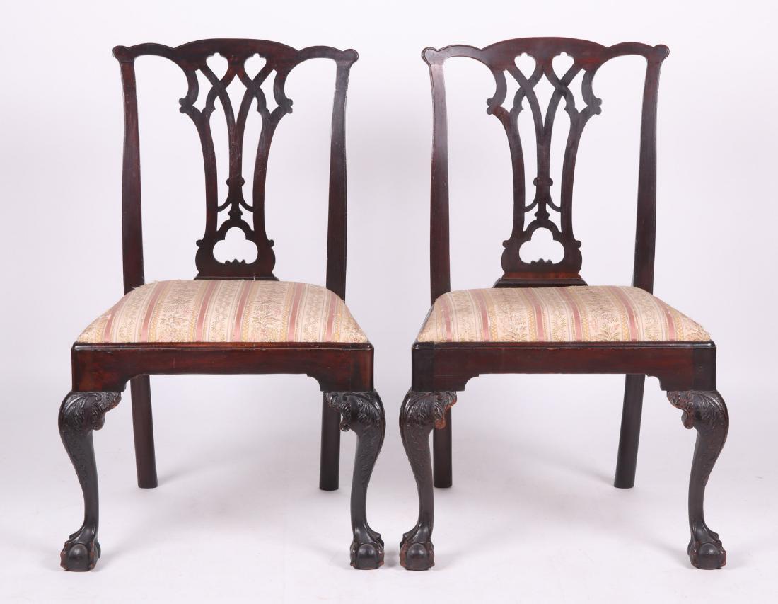 A Pair of American Period Chippendale Side Chairs: 18th century, mid Atlantic states. Each with ball and claw foot below cabriole legs with acanthus carved knee, trapezoidal slip seat, and a Gothic back. Dimensions: Each seat is 23" x 17", seat height