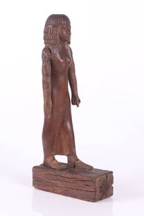 An Ancient Egyptian Wooden Figure: Depicting a walking woman, the base, front half of the feet and arms appear to be ancient, the rest of the piece is modern conjectural restoration. Dimensions: 8" x 3", 18" tall. Provenance: From a Ca