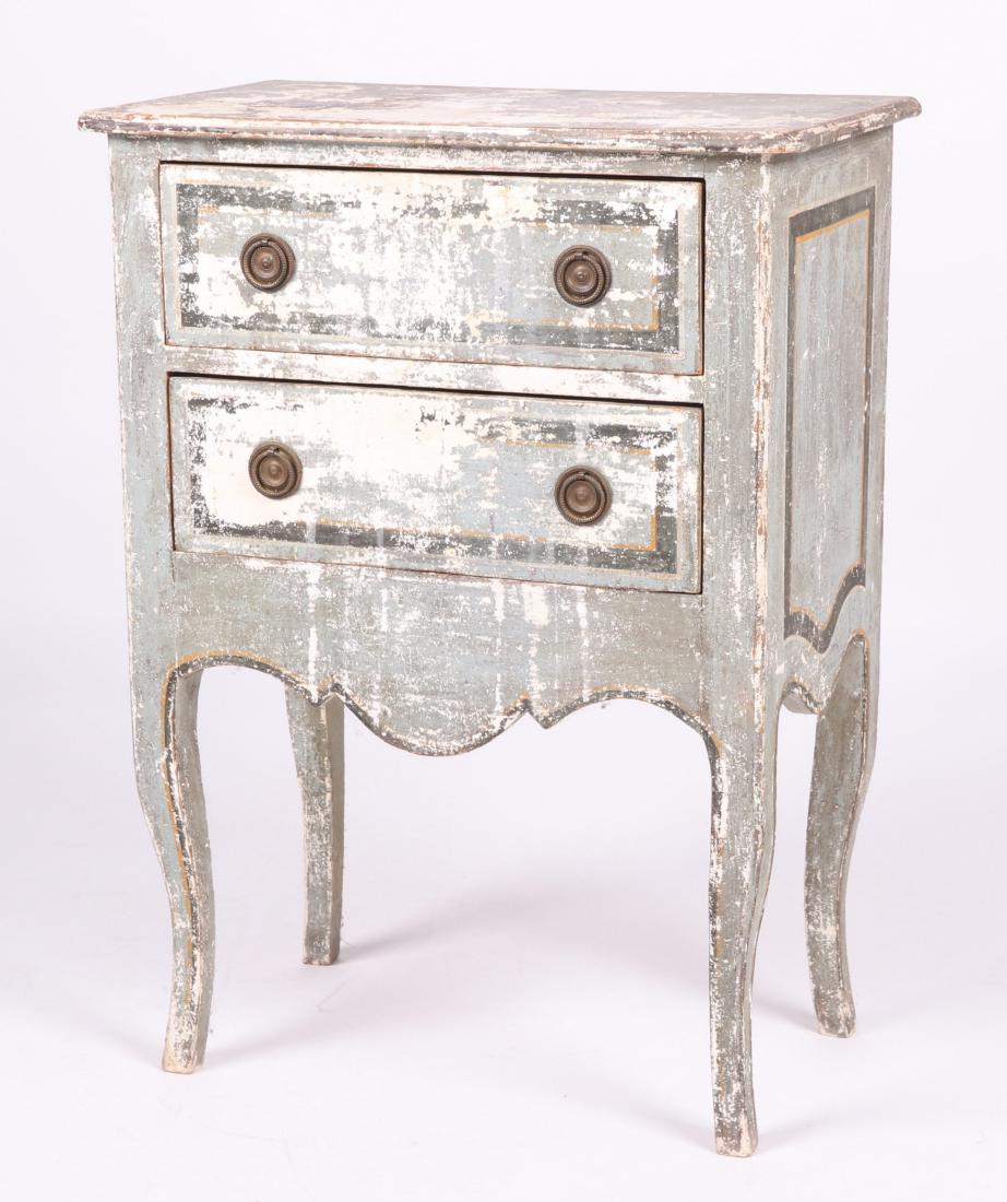 A Small Continental Commode: Late 19th or early 20th century. Cabriole legs, two drawers, below a conforming rectangular top, with a painted surface and ring pulls. Dimensions: The top is 23" x 13 3/4", 31 1/2" in height. Provena