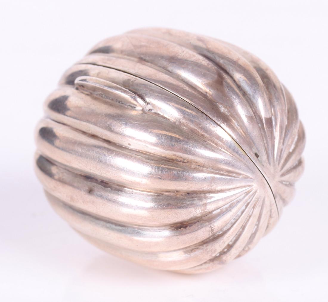 Tiffany Sterling Silver Nutmeg Grater: In the form of a nutmeg seed, with gold washed interior, and metal grater, marked as pictured. Dimensions: 1 1/2" x 1 1/4". Approximate gross weight of 1 troy ounce. Provenance: From a local estate.