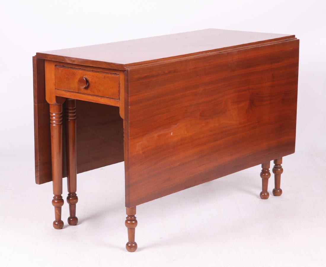 American Walnut Drop Leaf Dining Table: From the first half of the 19th century. Solid walnut, with six legs, single dovetailed drawer, and long hinged leaves. Dimensions: The top is 46" x 19" in the closed position, each leaf is 21", 30" i