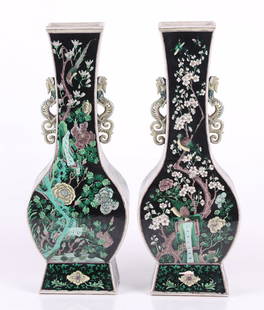 A Large Pair of Chinese Famille Noir Vases: Kangxi mark but later, each with a canted retangular foot below the bottle form body which features fully realized dragon handles. The green, yellow and aubergine decoration features birds in a lush g