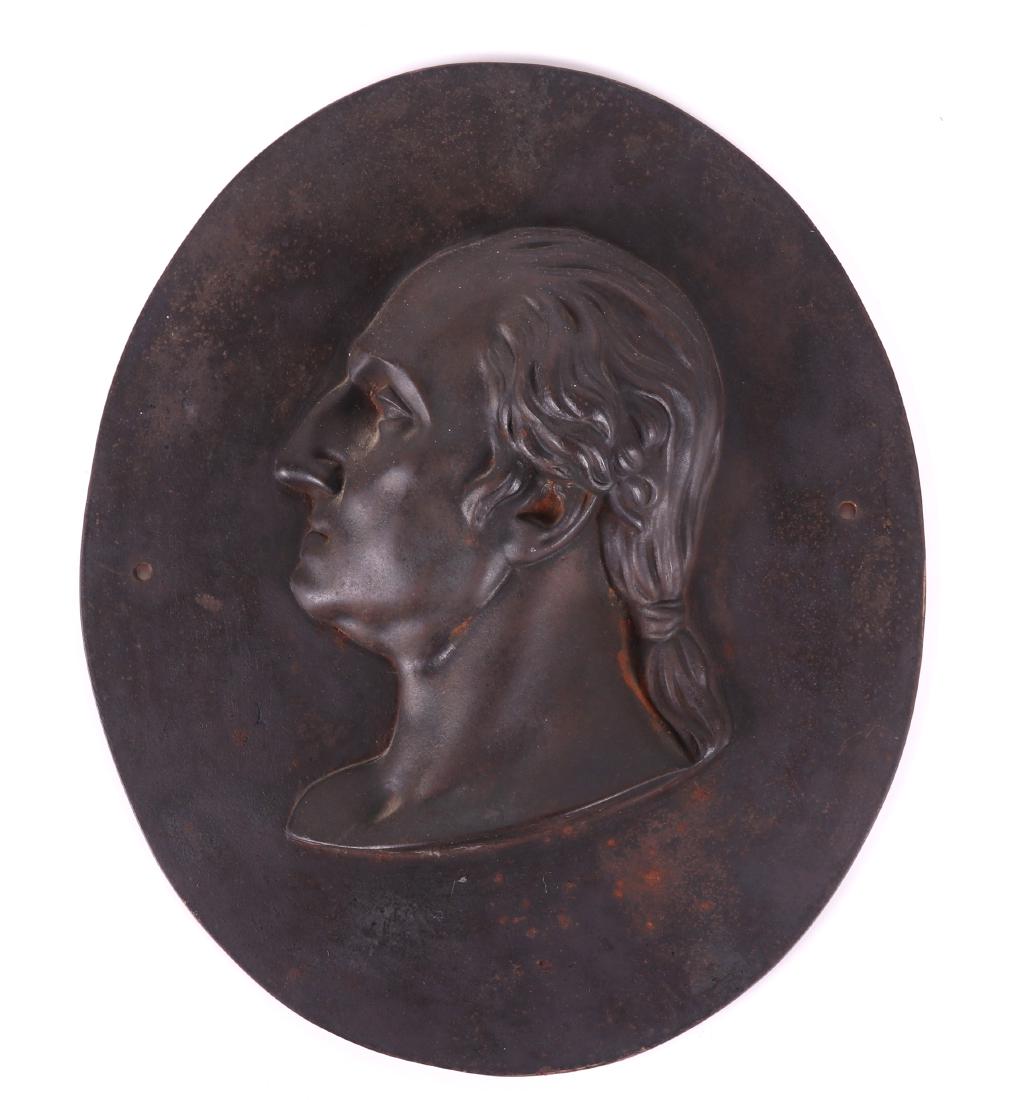 A 19th Century Cast Iron Plaque, Washington: Oval with mounting holes and high relief head in profile. Dimensions: 11 1/2" x 9 3/4". Provenance: From a Chester County estate.