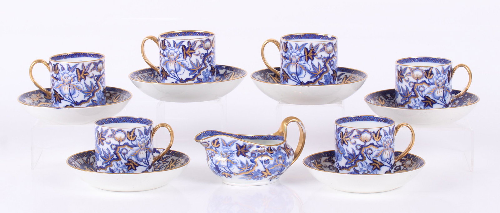 Circa 1820 Wedgwood Pearlware Cups and Saucers: A set of six cups, six saucers and a creamer, all in a peony pattern with gilt elements, impressed marks as pictured. Dimensions: The cups have a diameter of 2 1/2" and are 2 1/2" tall, each saucer is
