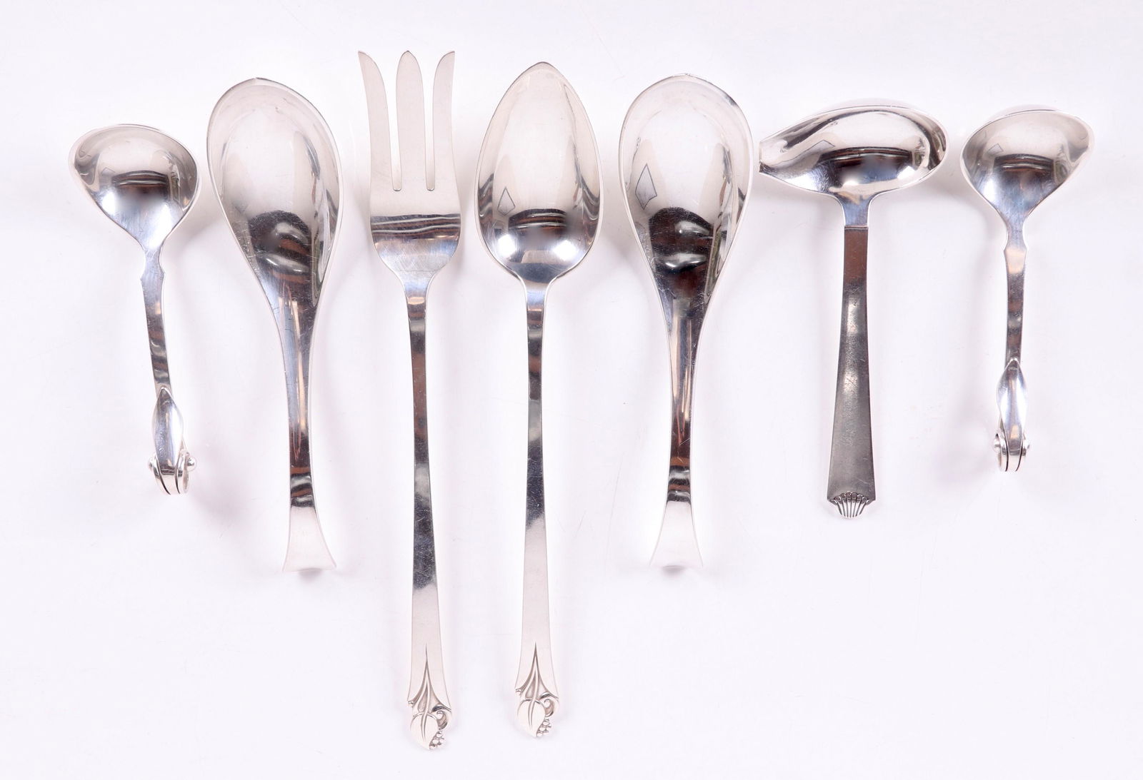 Danish Sterling Ladles, Jensen Style Salad Set: Comprising: a pair of 8" ladles, by C. Antonsen; a pair of 6" ladles with scrolling foliate terminals, by Cohr; a 6 3/4" ladle, "Vendome" by Hans Hansen; a salad set with 11 1/2" fork and spoon, "Wood