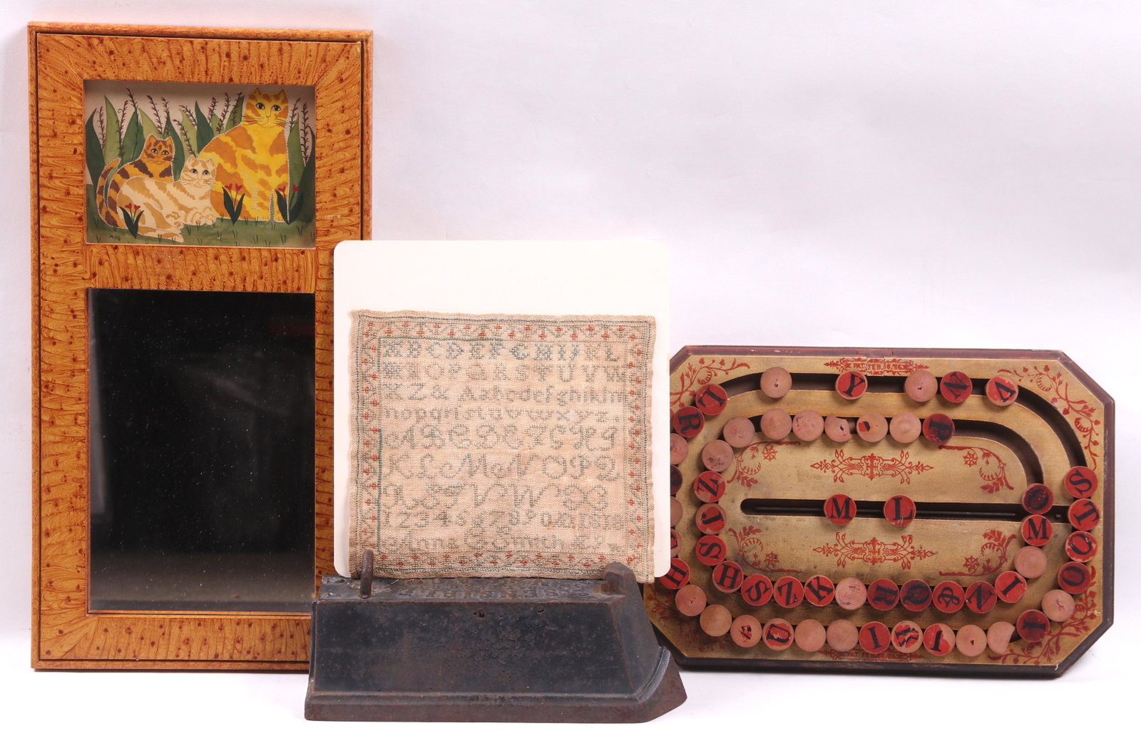 Estate Lot: Folk Art, Domestic Items: A sampler with strawberry border, signed Anna C. Smith, age 9, dated 1818; a Universal Spelling Board, late 19th century; a late 20th century Pennsylvania folk art watercolor of cats, signed "MEG", fr